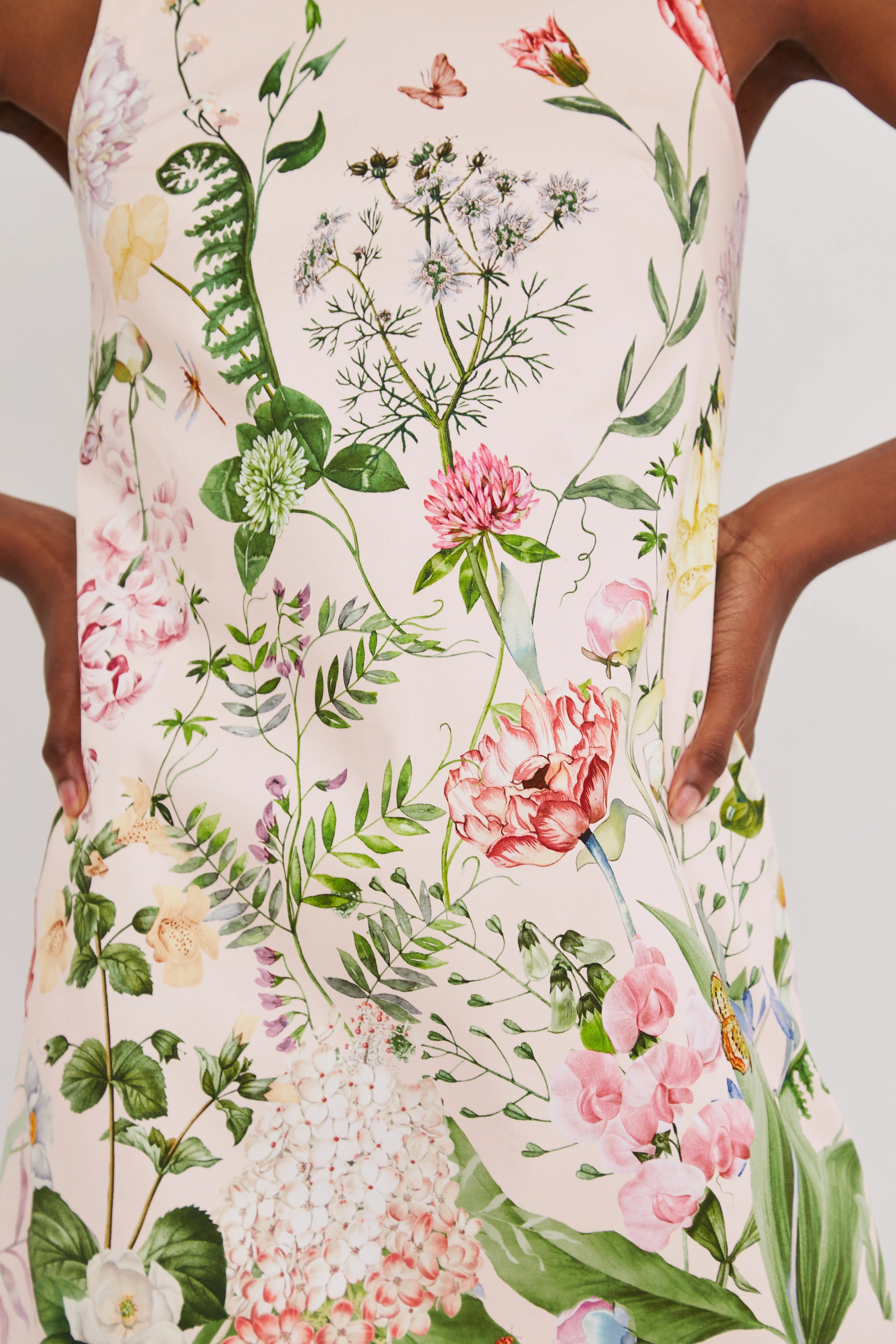 Floral dress with pink flowers and green leaves on a white background