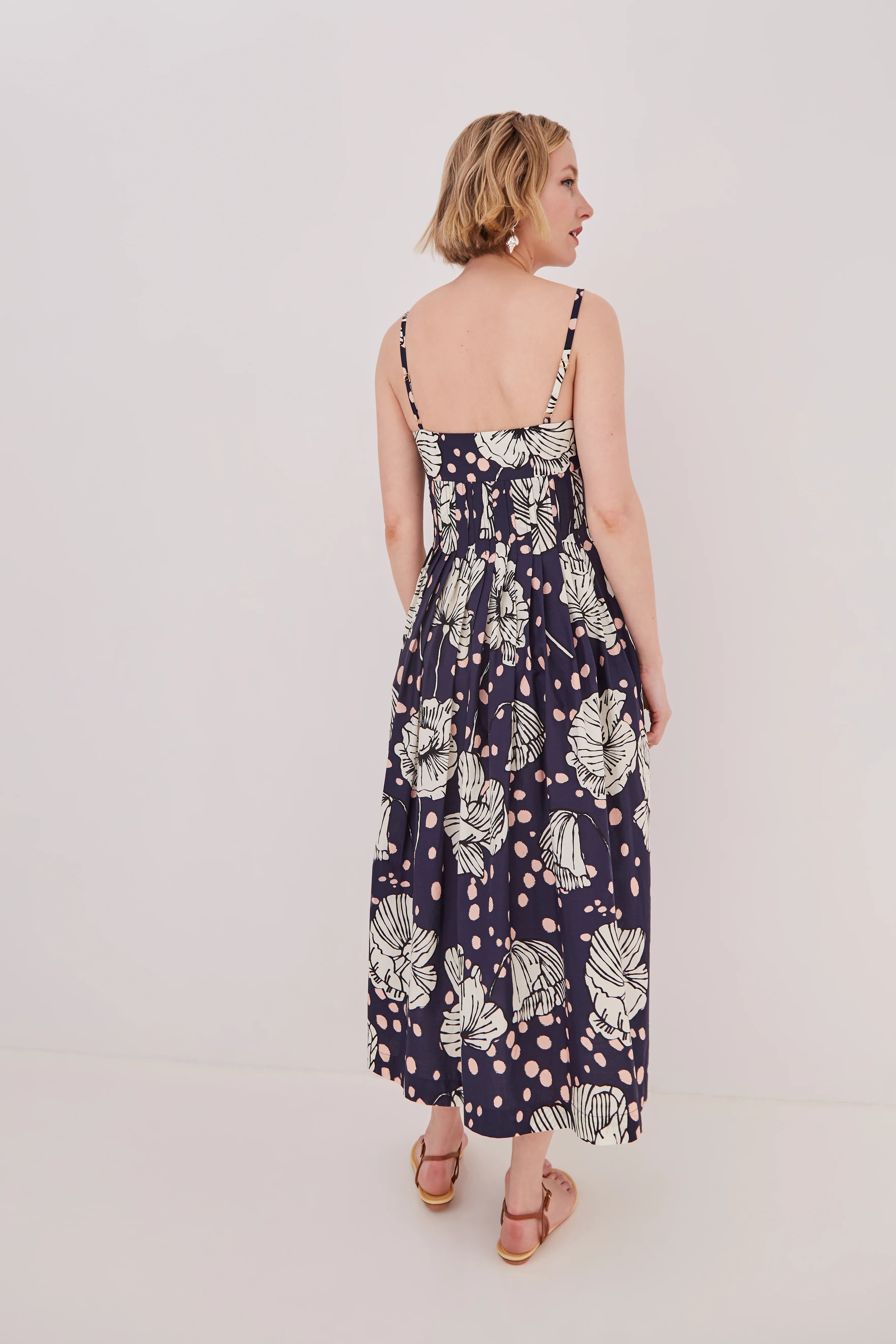 Woman wearing a floral dress on a plain background