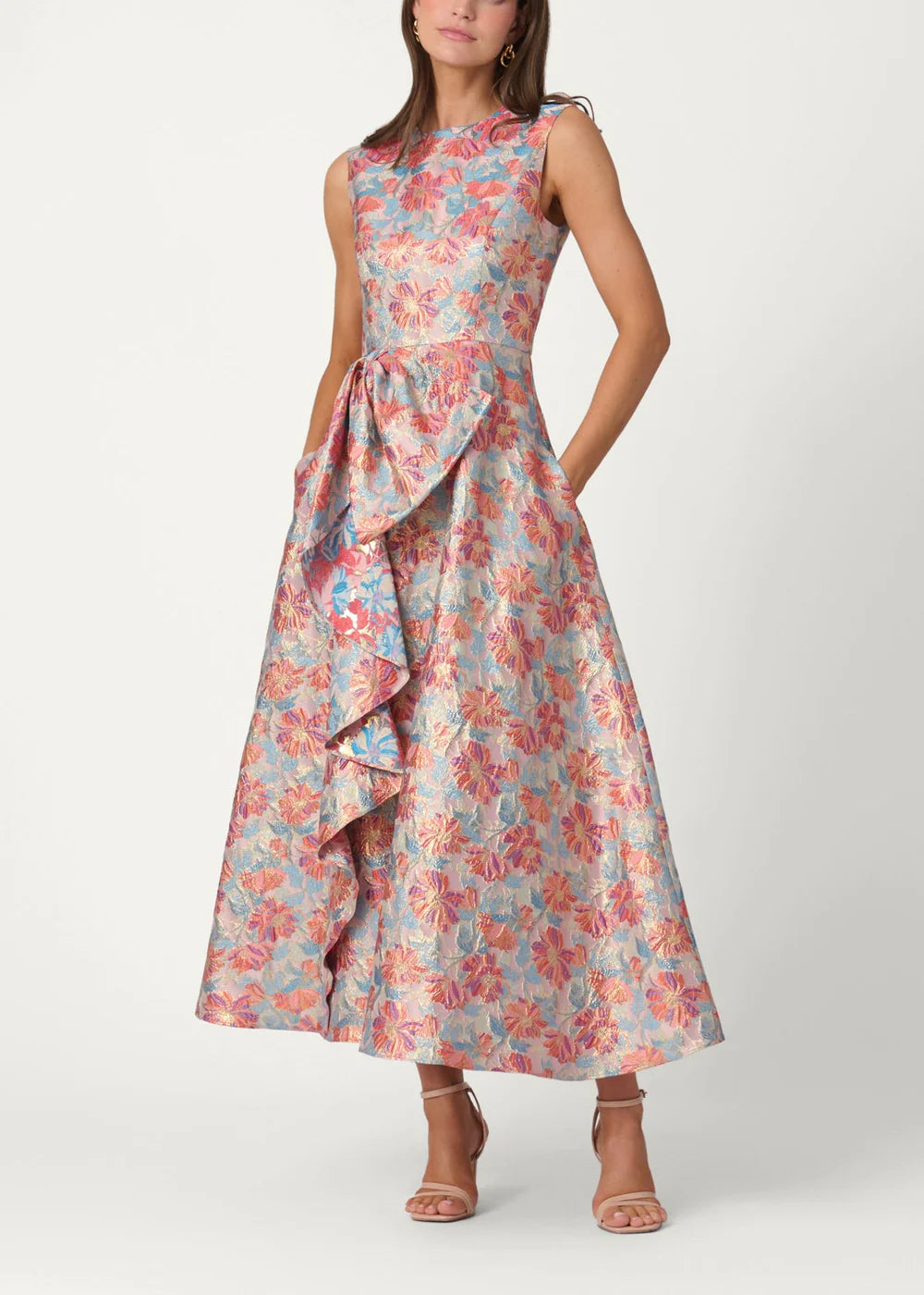 Woman wearing a floral dress with ruffled details on a white background