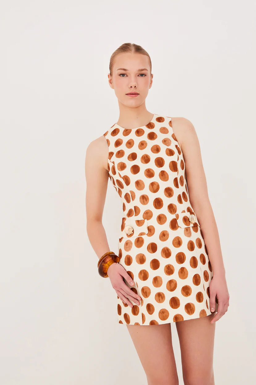 Woman wearing a polka dot dress on a white background