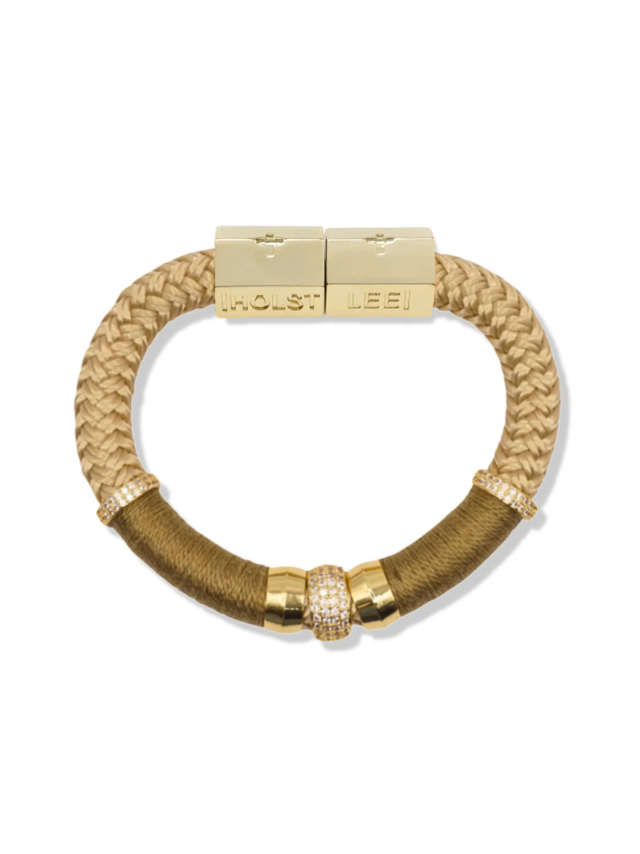 Gold and beige braided bracelet with a clasp on a white background