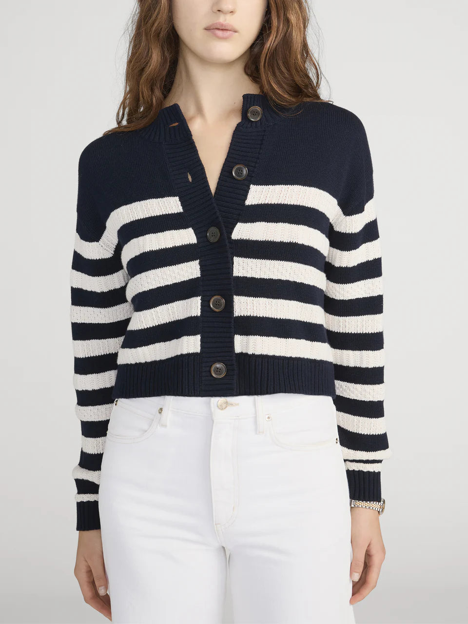 Navy and white striped cardigan worn by a person on a plain background
