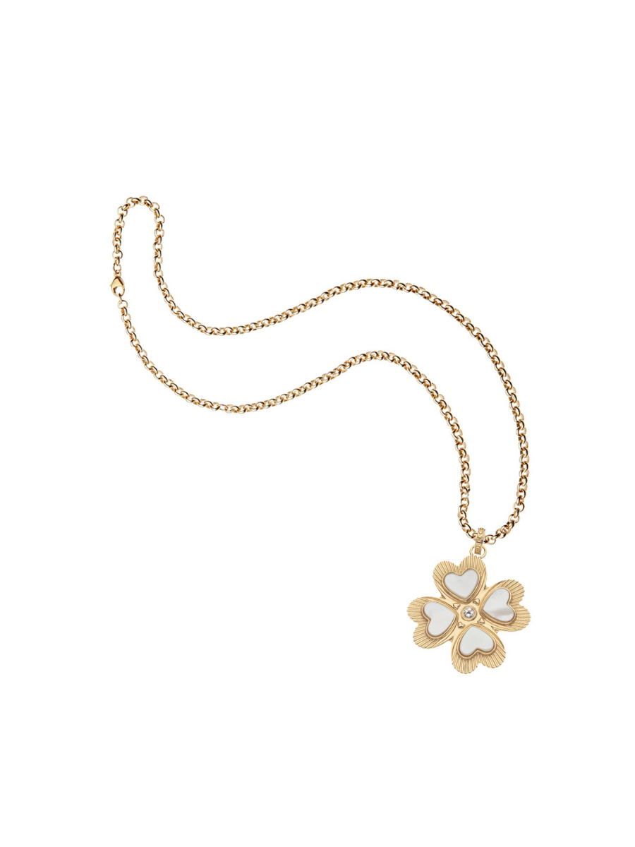 Gold necklace with a white flower pendant on a white background