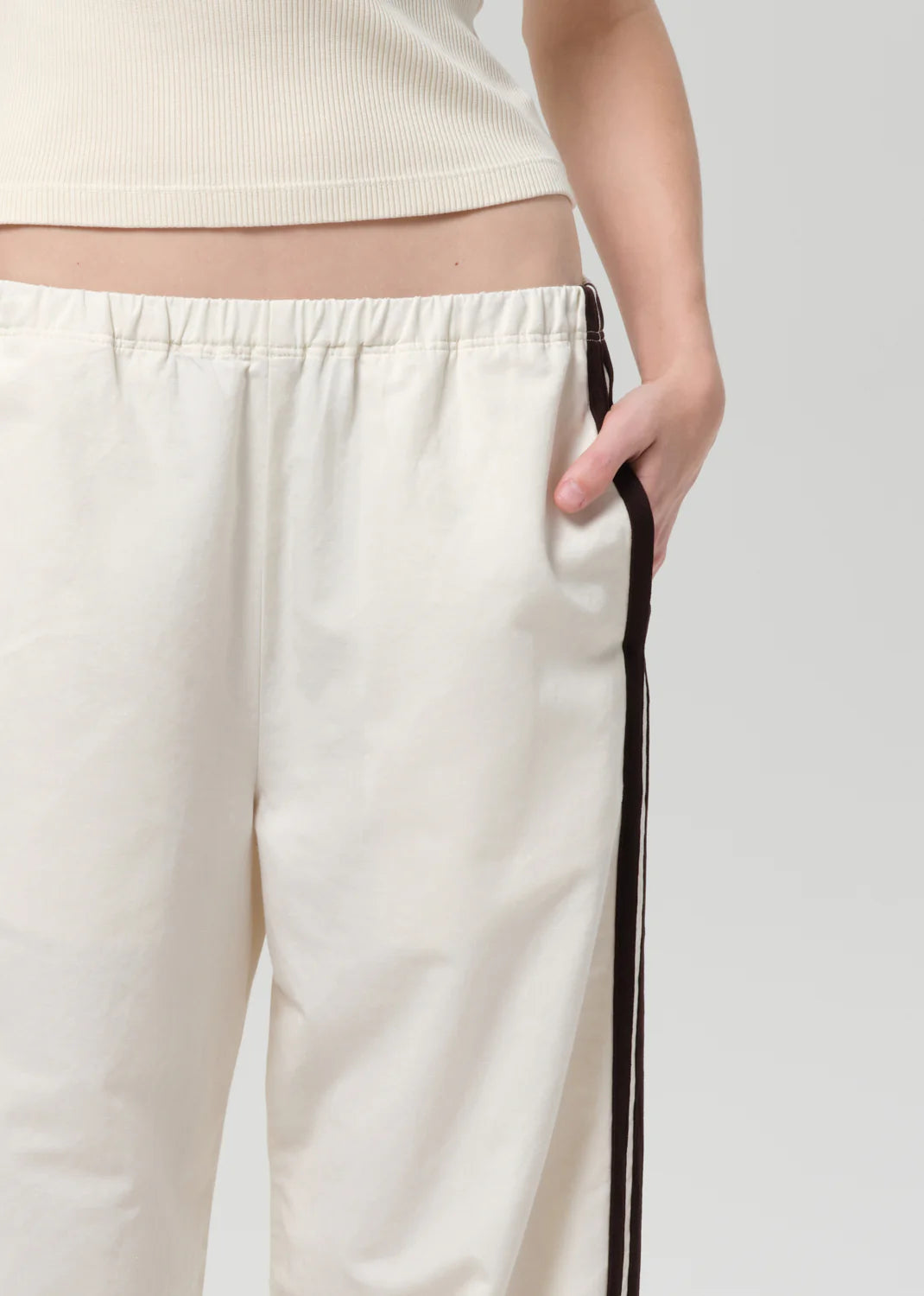 White pants with a black stripe on a white background