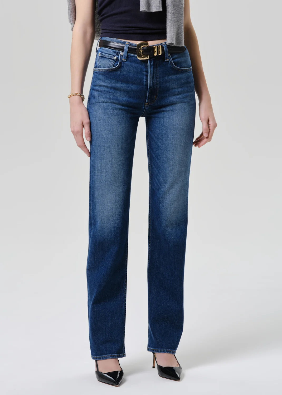 Person wearing blue jeans with a white background