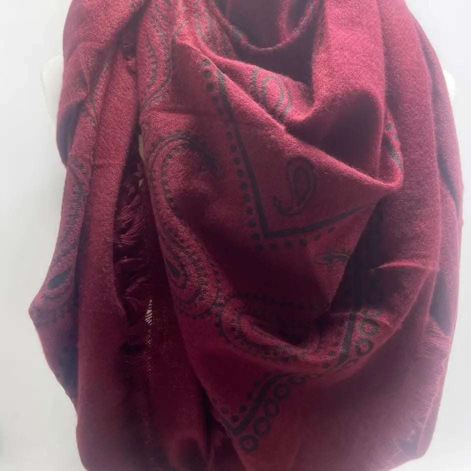 Red scarf with black patterns on a white background