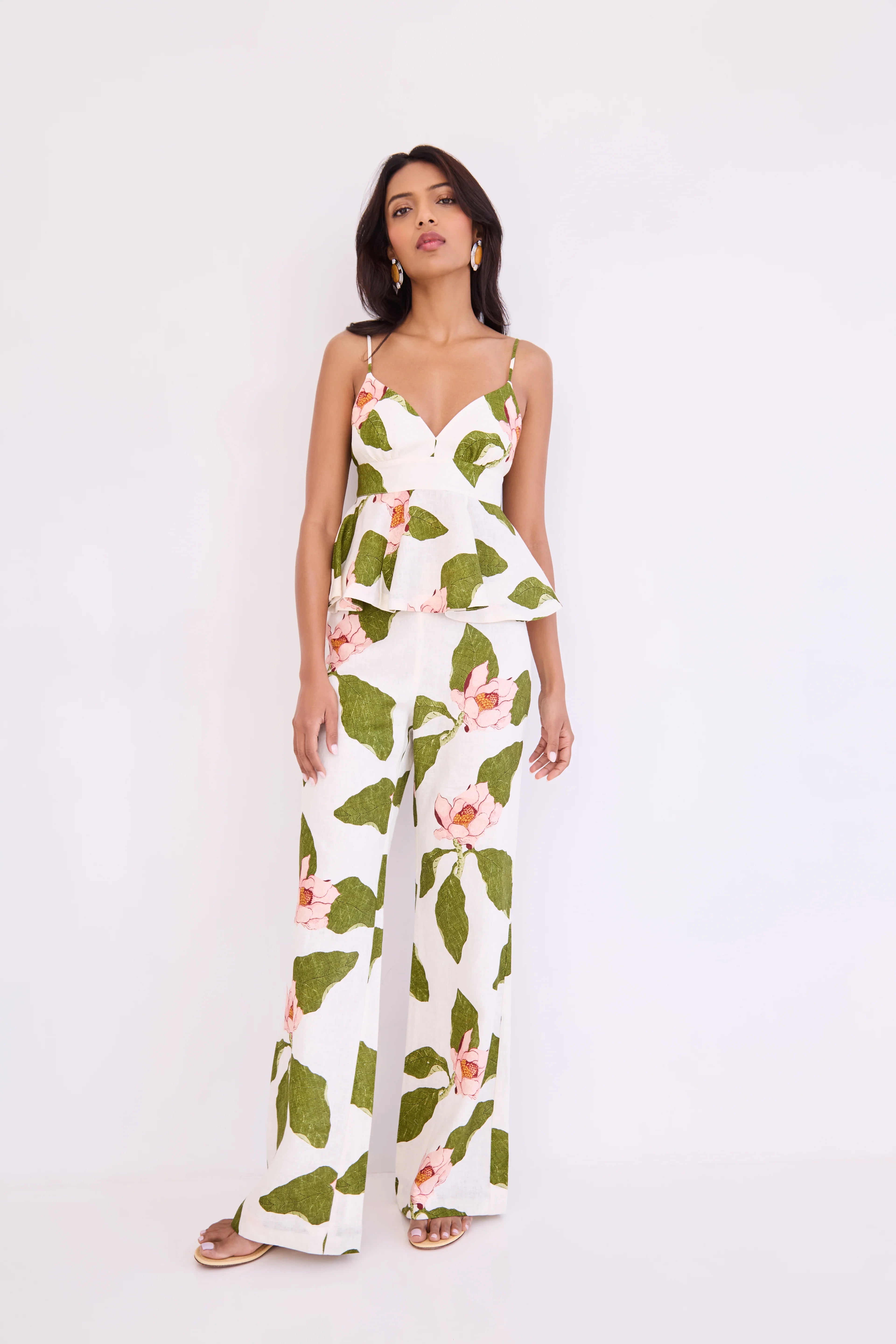Woman wearing a floral jumpsuit on a white background
