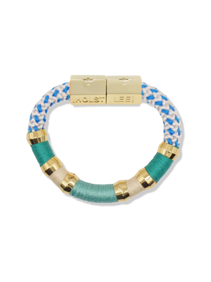Bracelet with blue and white patterned band and gold accents on a white background