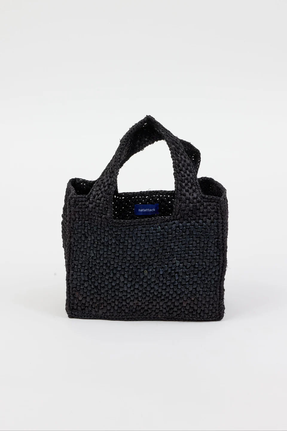 Black woven handbag with a visible brand logo on a white background