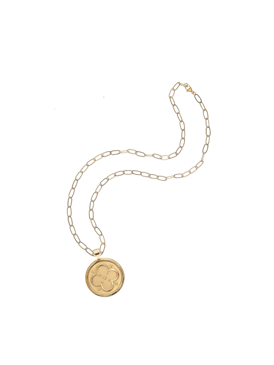 Gold necklace with a round pendant on a white background