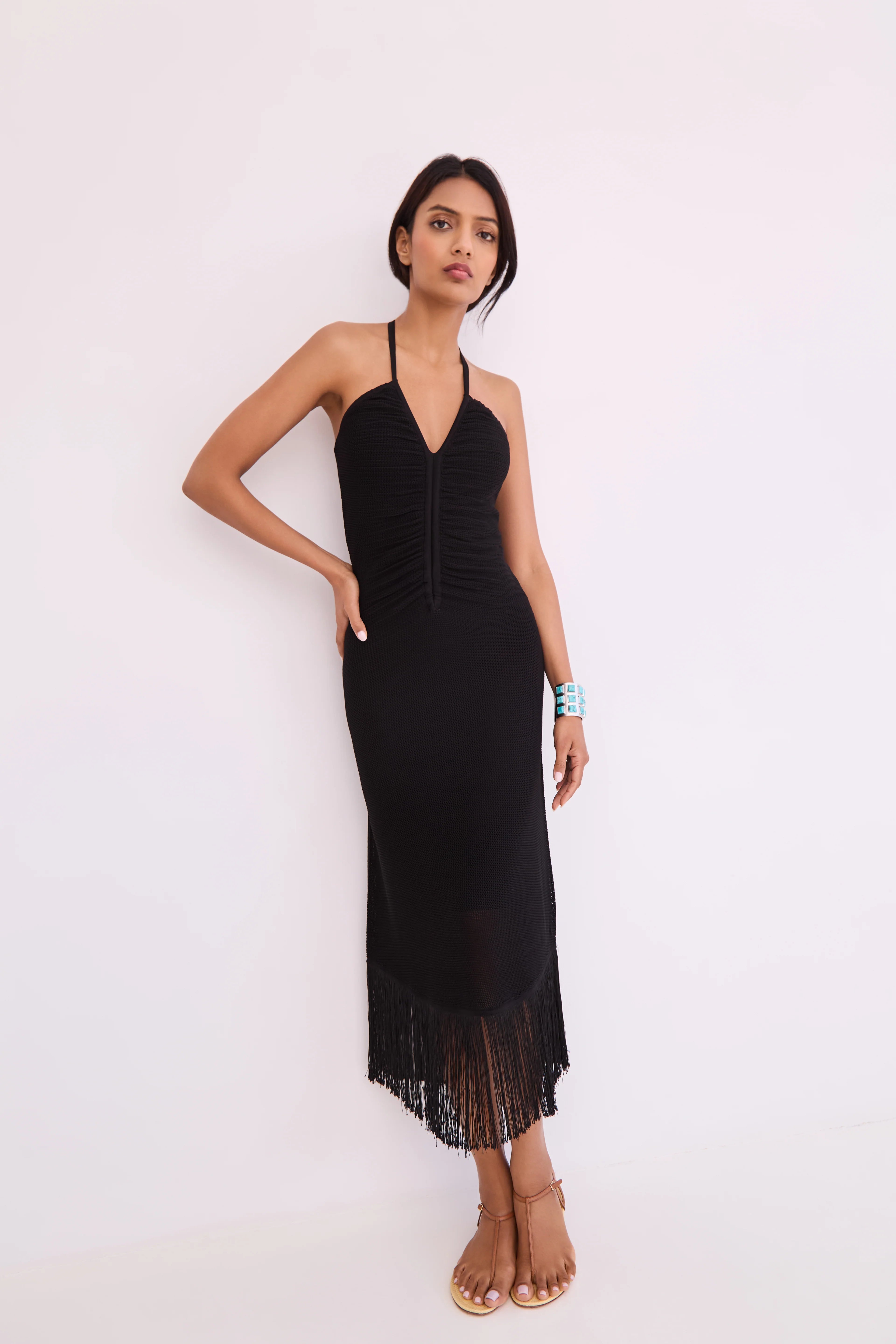 Woman wearing a black dress with a white background