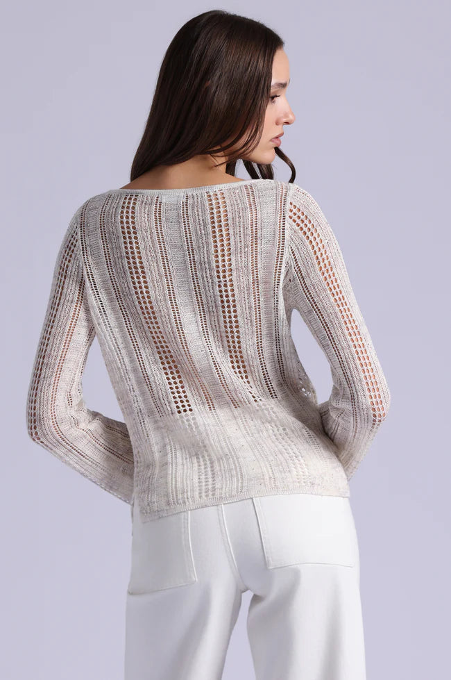Woman wearing a patterned sweater on a plain background