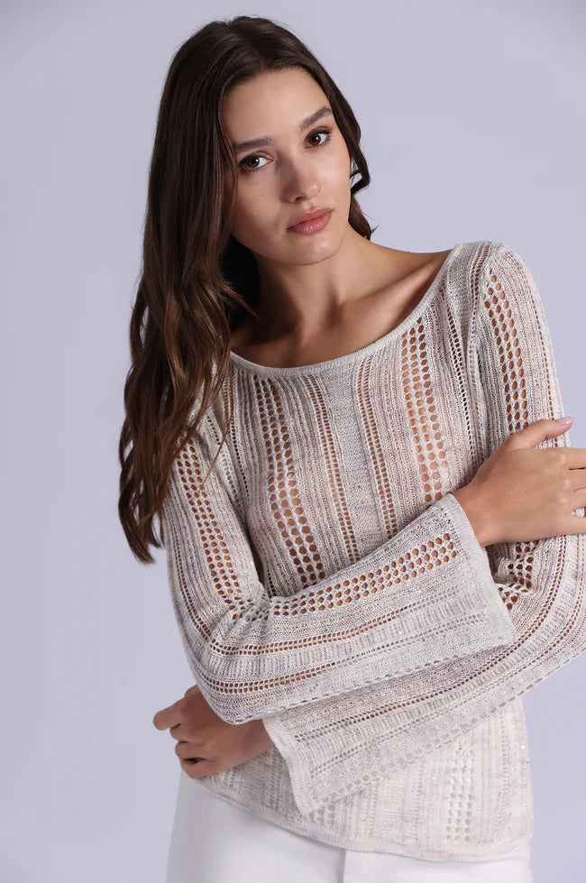 Woman wearing a patterned sweater against a plain background