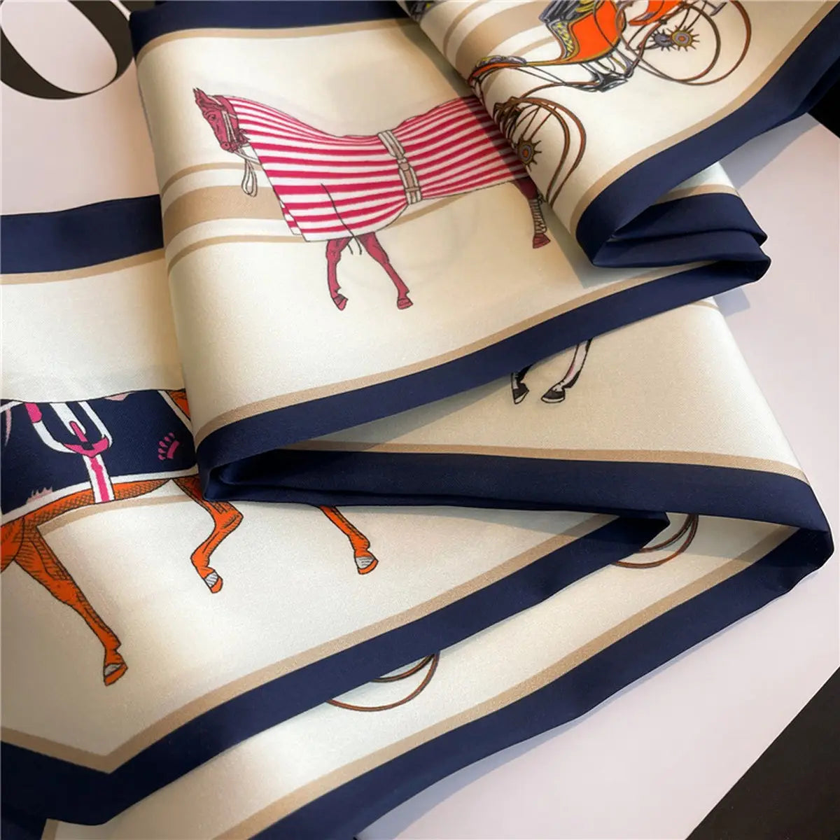 Folded fabric with horse and carriage pattern on a white background