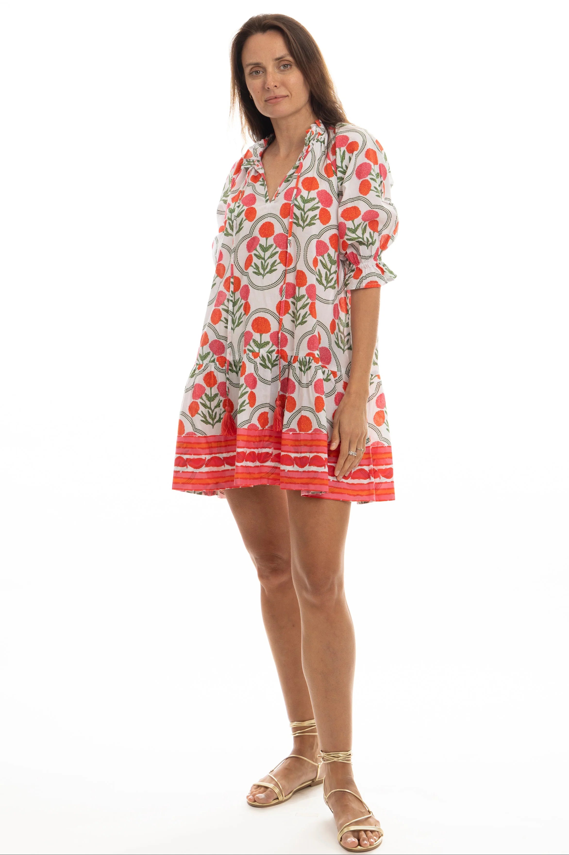 Woman wearing a colorful patterned dress on a white background
