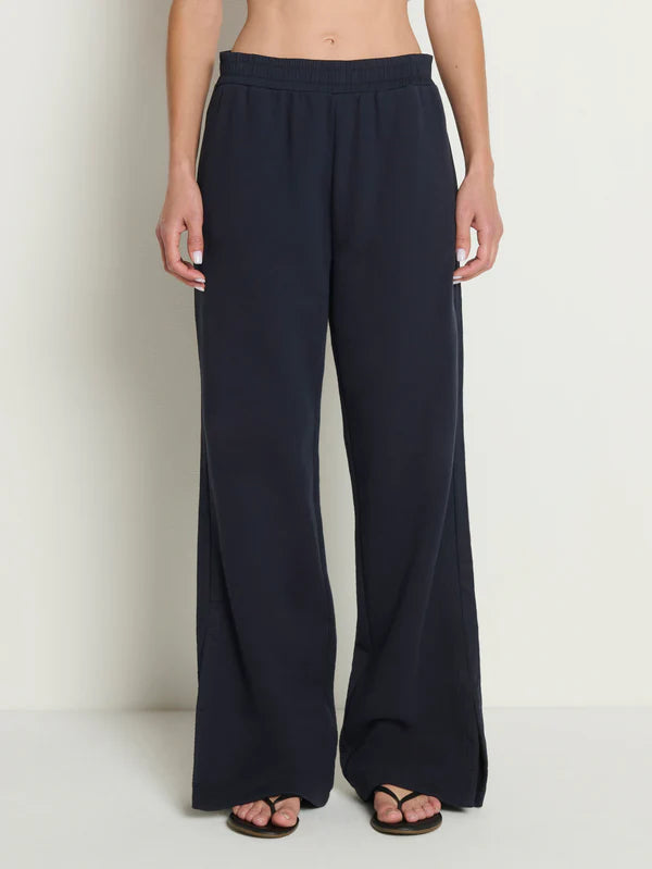 Navy blue wide-leg pants worn by a person on a white background