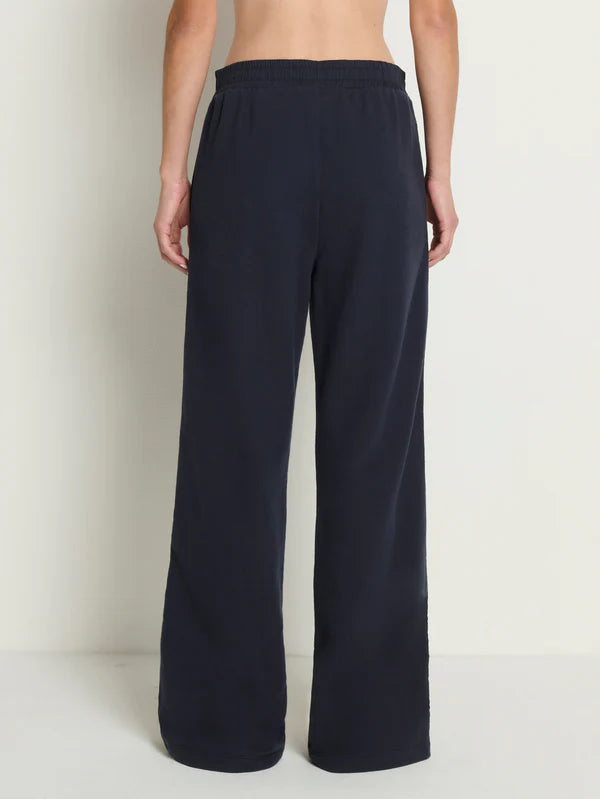 Navy blue wide-leg pants worn by a person on a white background