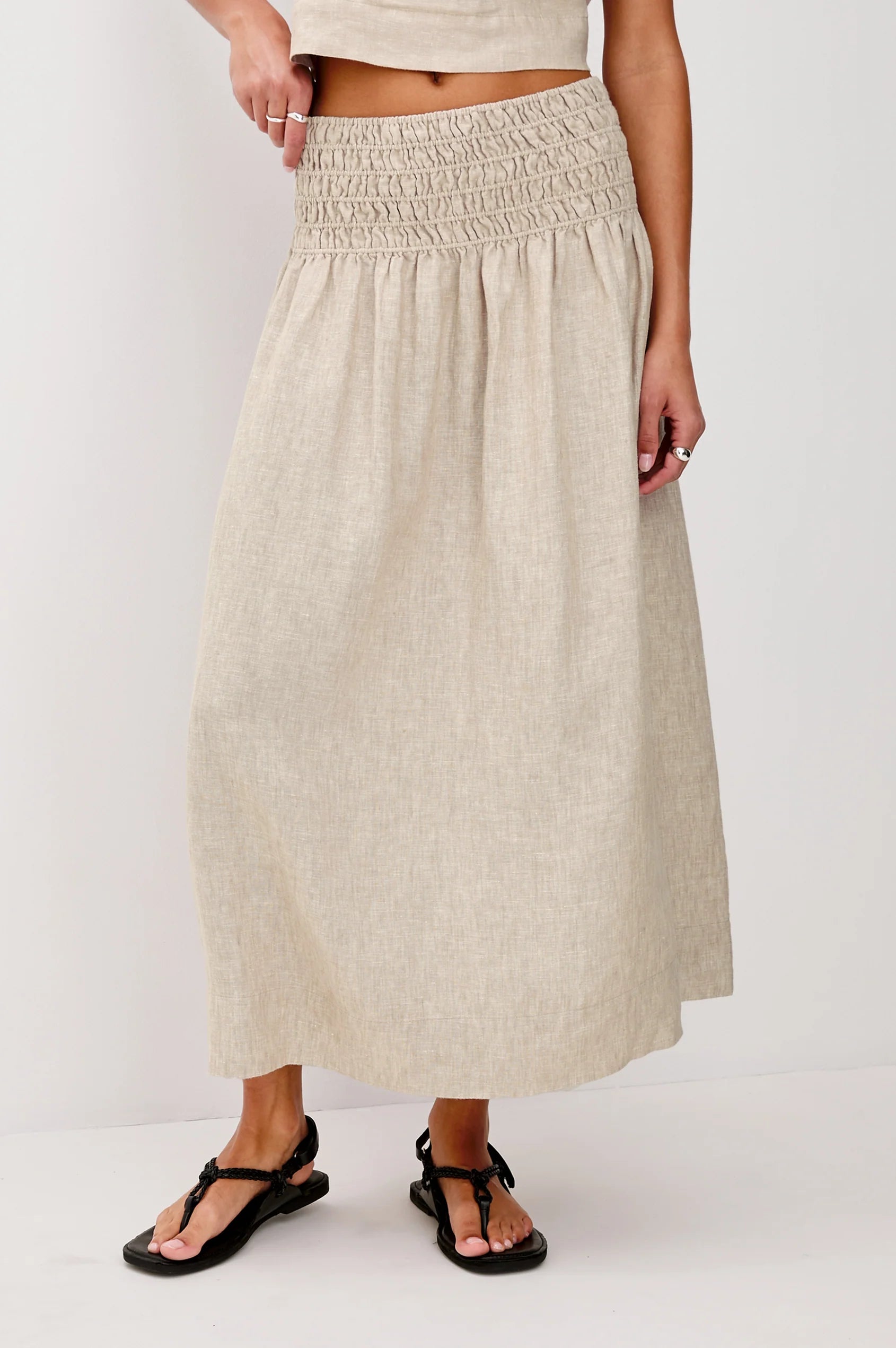 Beige skirt worn by a person on a white background