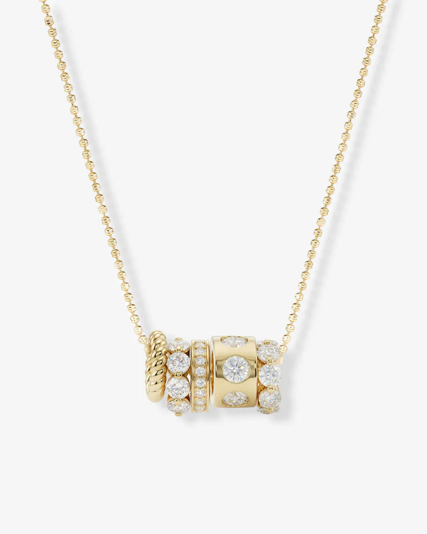 Gold necklace with diamond beads on a white background
