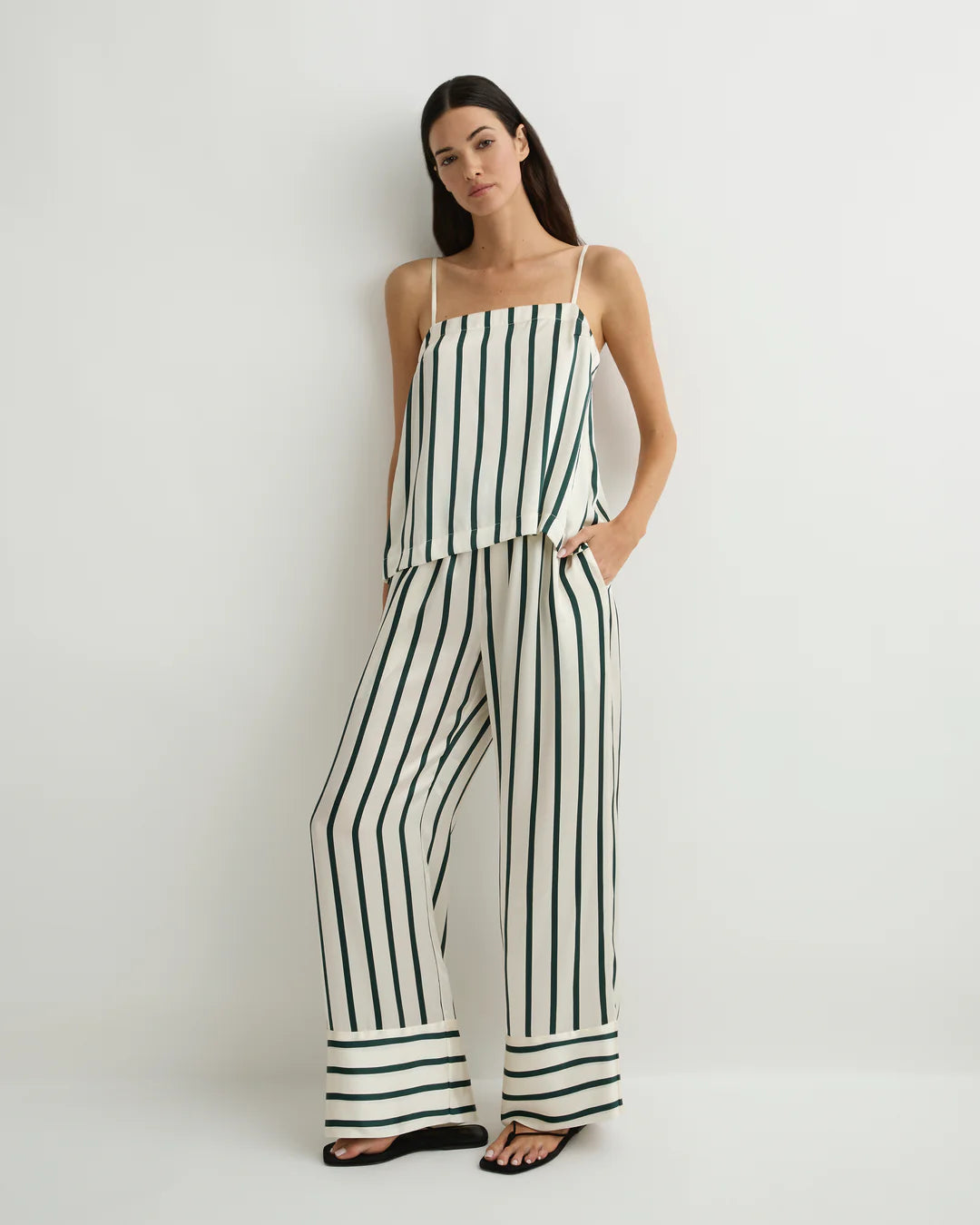 Woman wearing a black and white striped jumpsuit on a white background