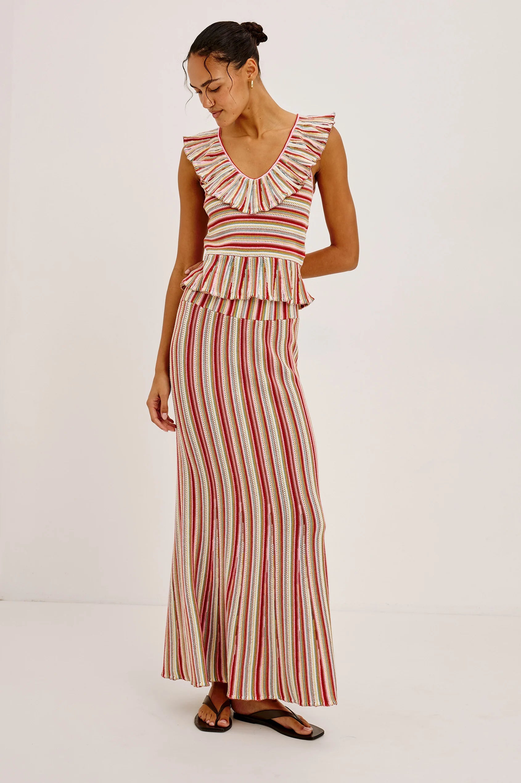 Woman wearing a red and white striped dress on a white background