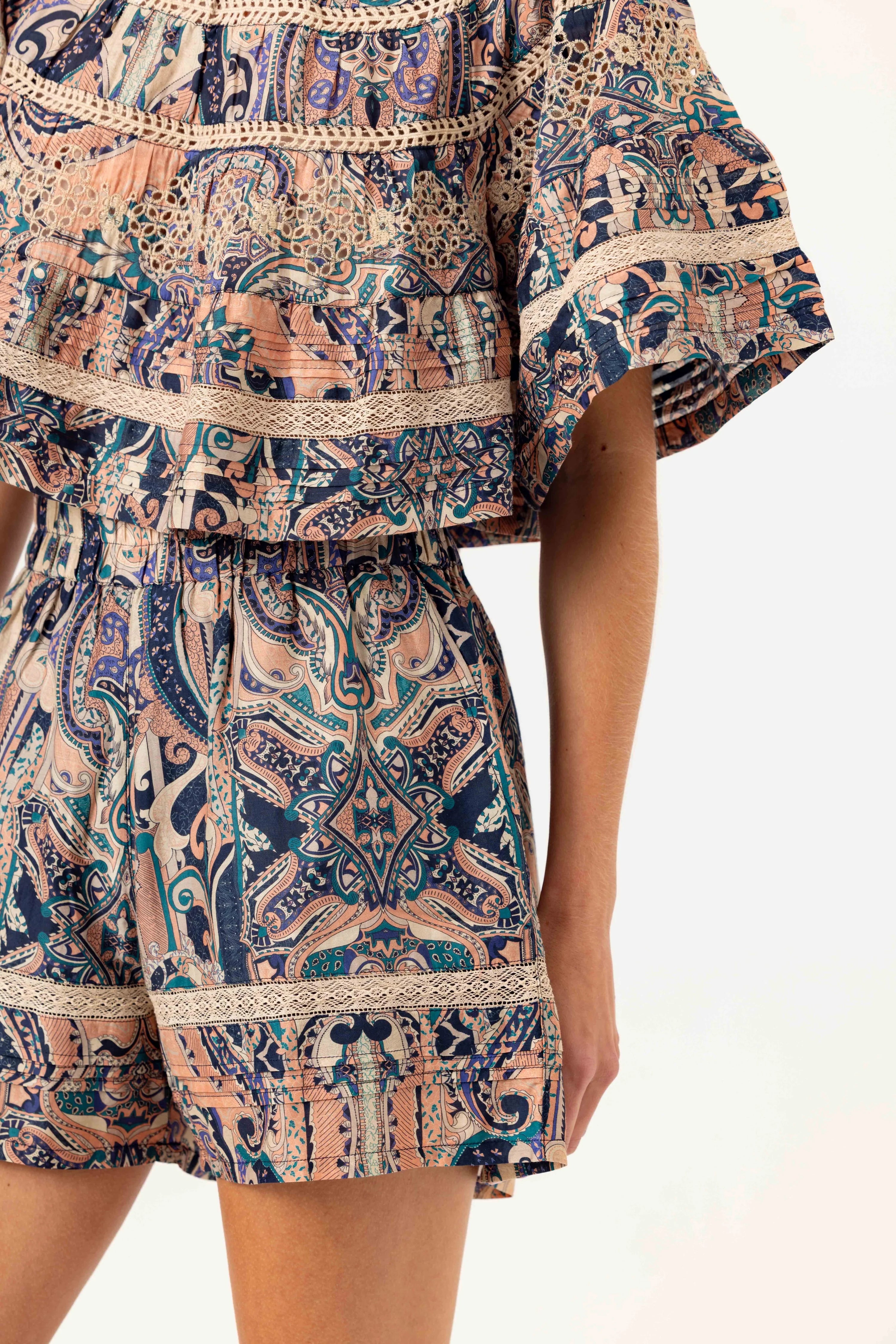 Patterned outfit with a top and shorts on a white background