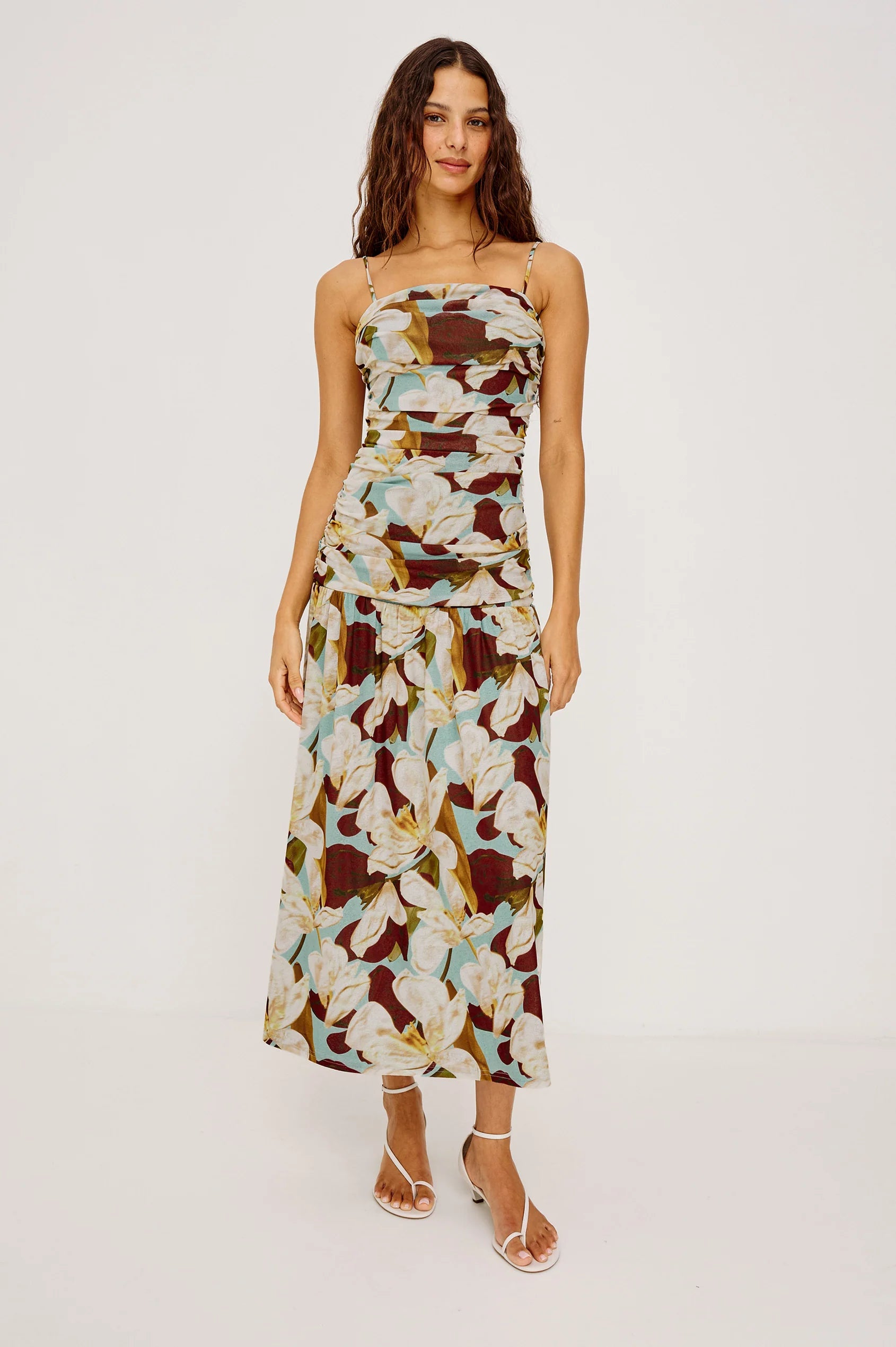 Woman wearing a floral strapless dress on a white background