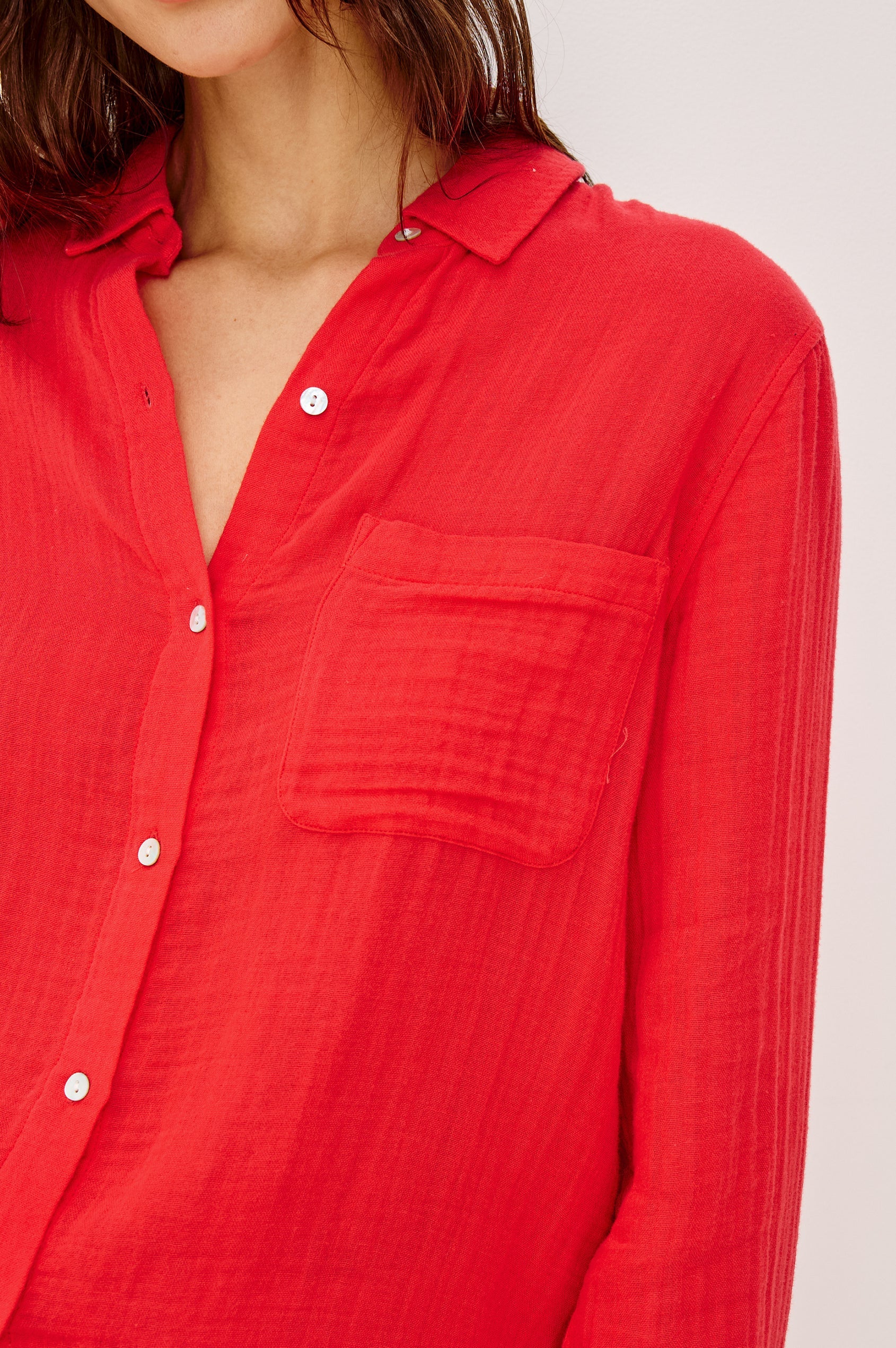 Close-up of a red button-up shirt with a neutral background