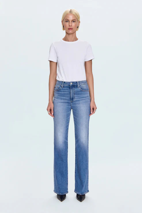 Person wearing a white t-shirt and blue jeans on a light gray background