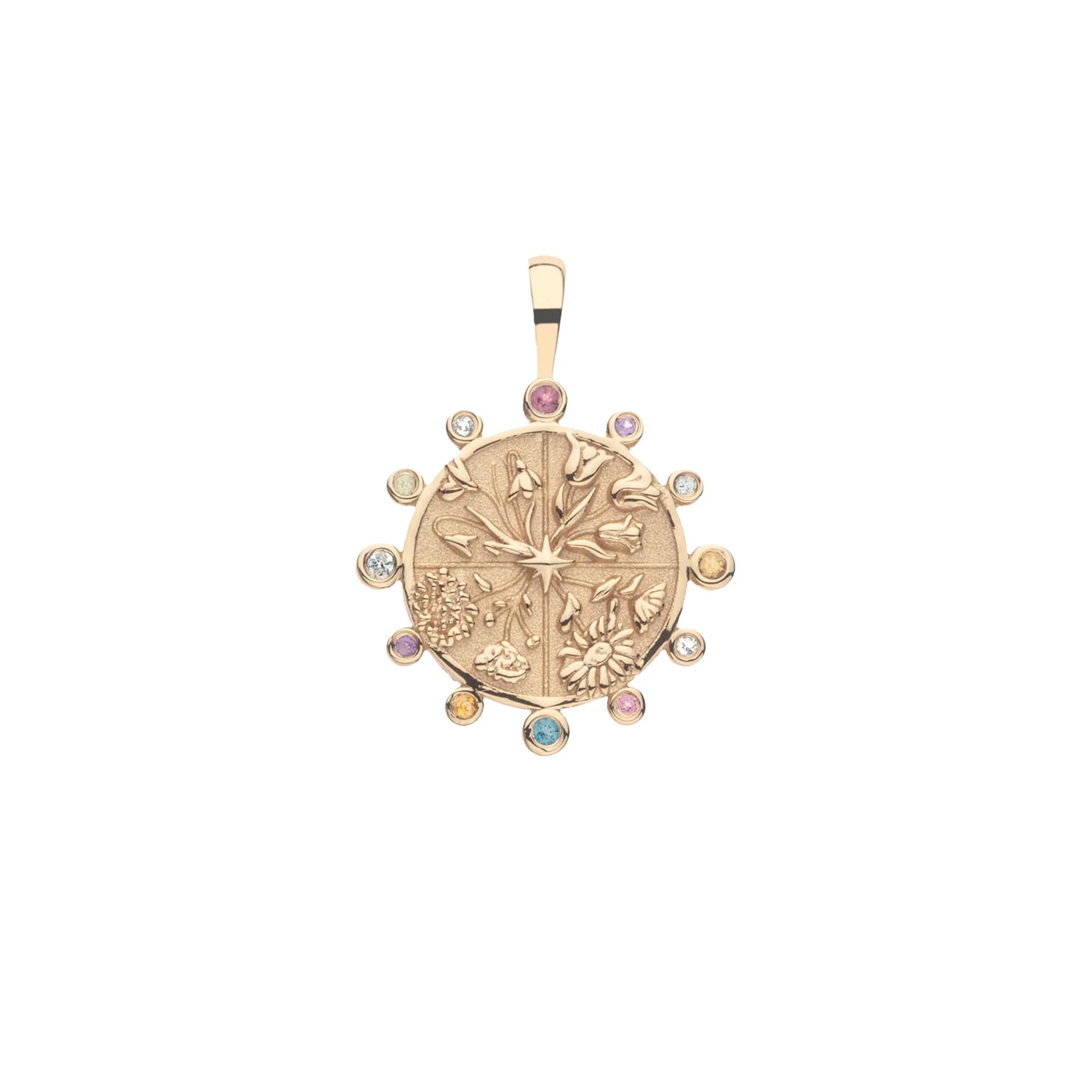 Gold pendant with gemstones on a white background