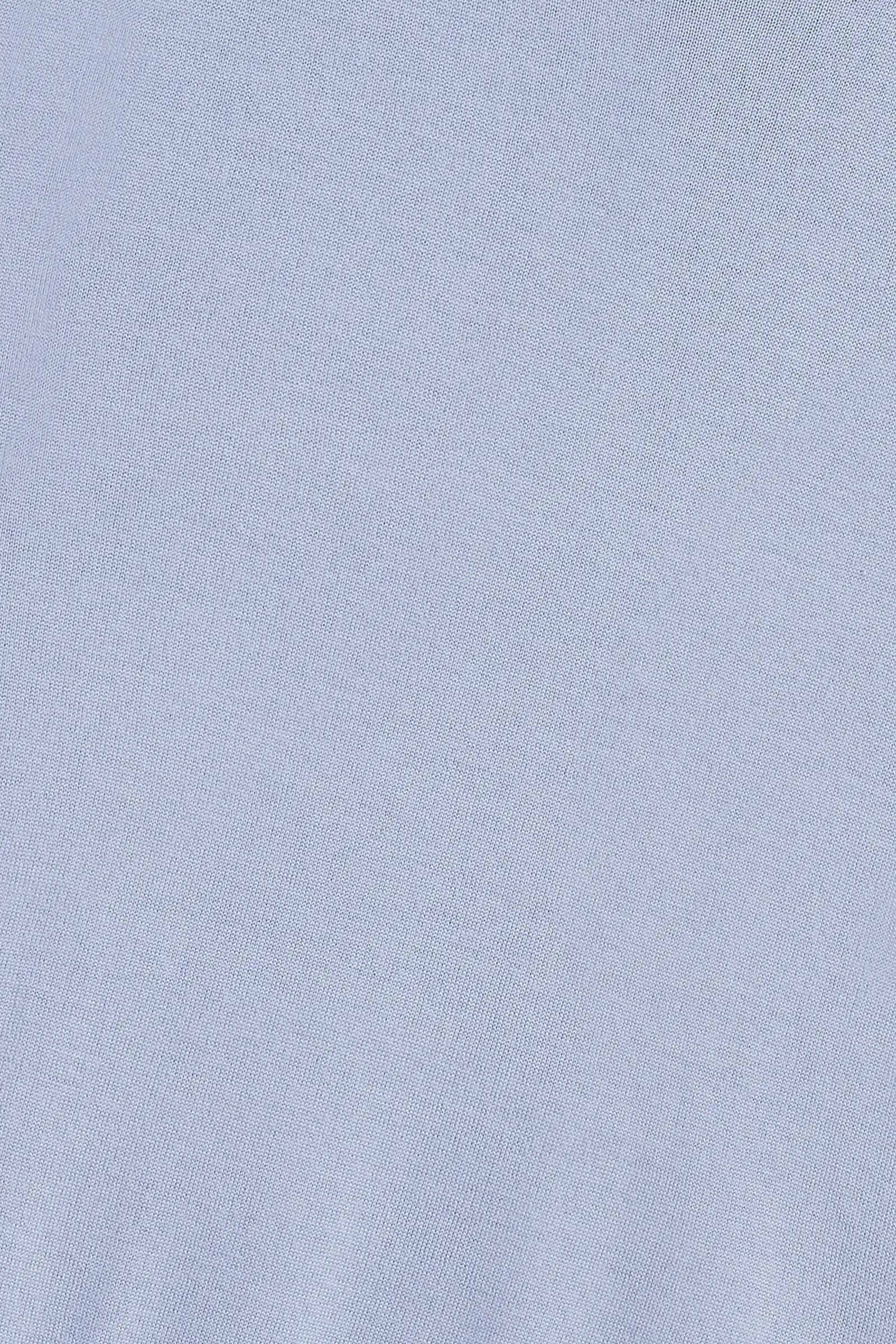 A close-up of a light blue fabric texture, likely a knit or jersey material.