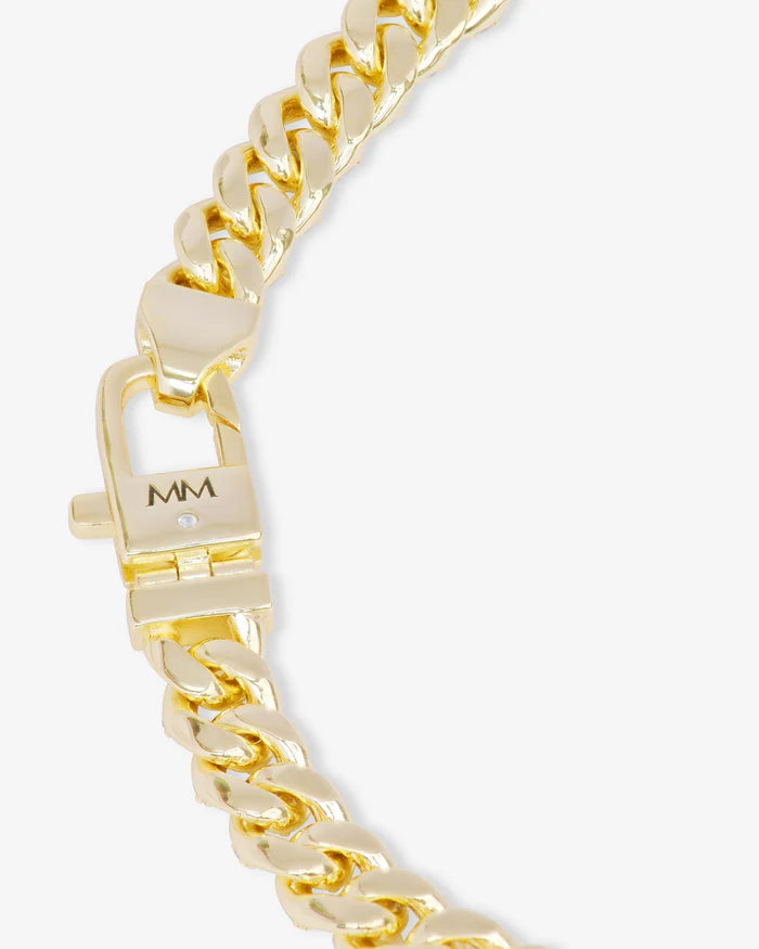 Gold chain bracelet with a clasp on a white background