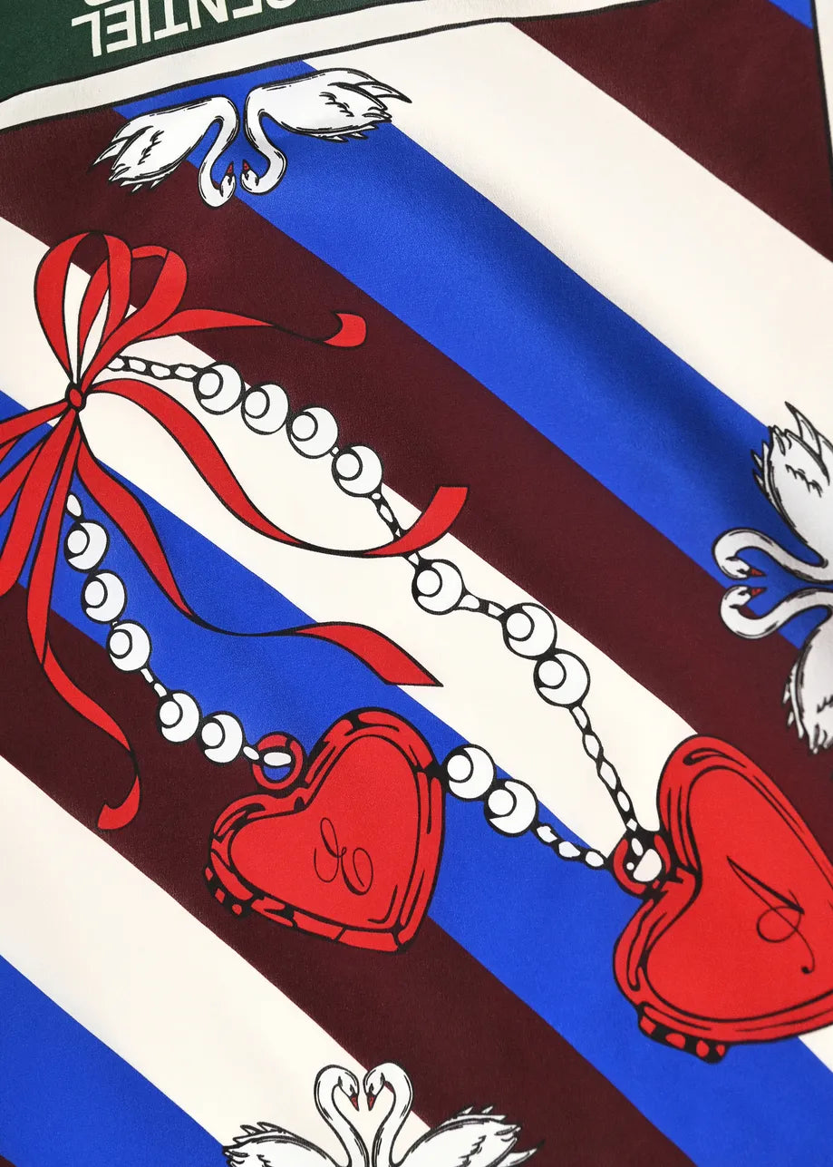 A square scarf from Essentiel Antwerp featuring a dark green border and a central graphic with diagonal blue, white, and burgundy stripes, red hearts, and a red ribbon.