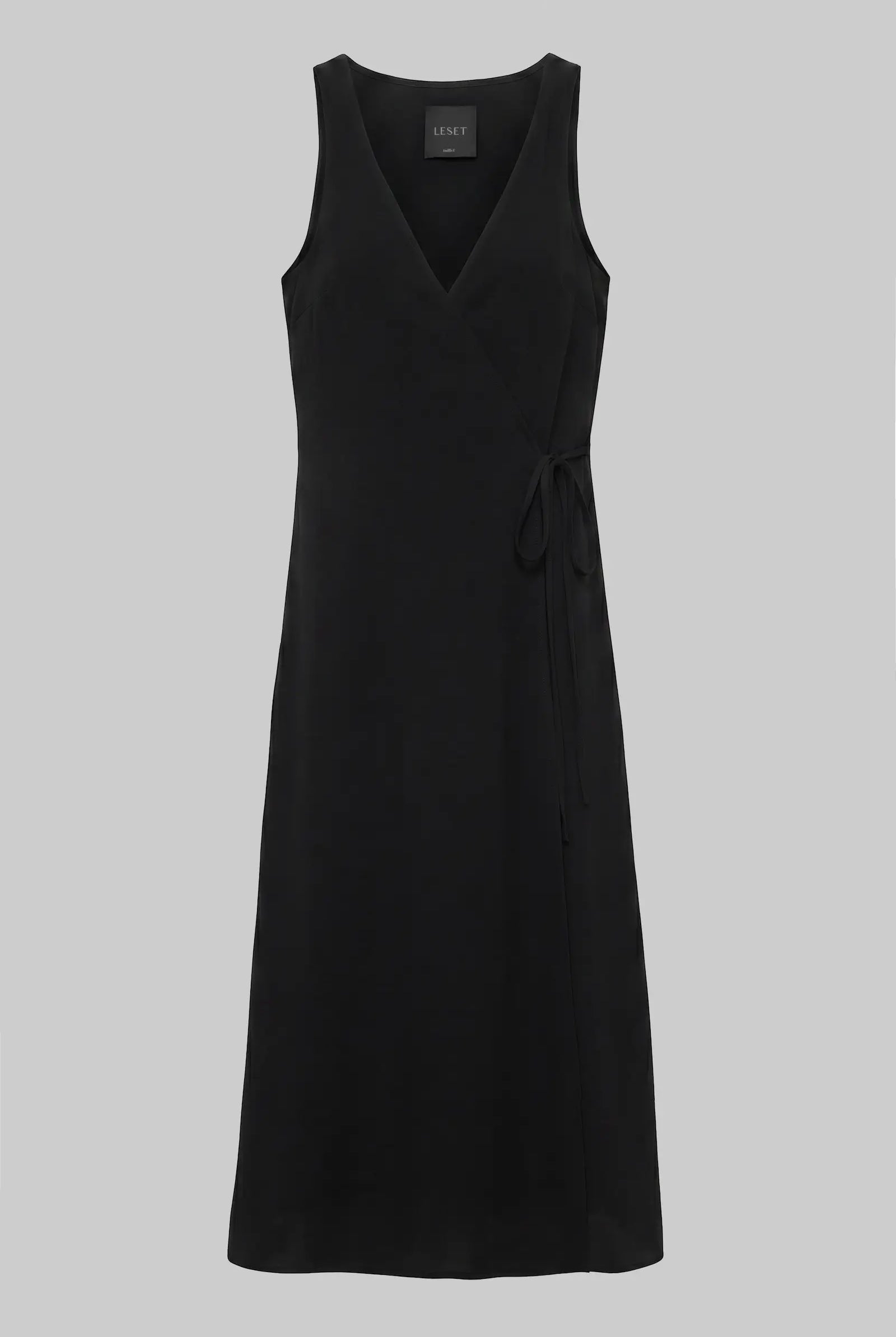 A black sleeveless wrap-style midi dress with a V-neckline and a self-tie waist, shown against a solid gray background.