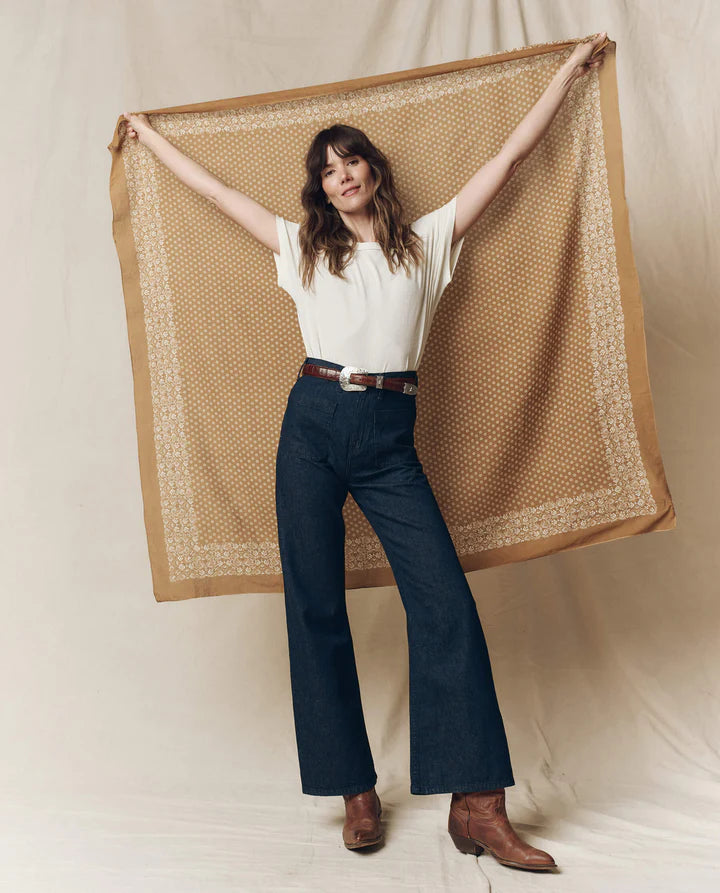 woman holding a bandana with a fabric background