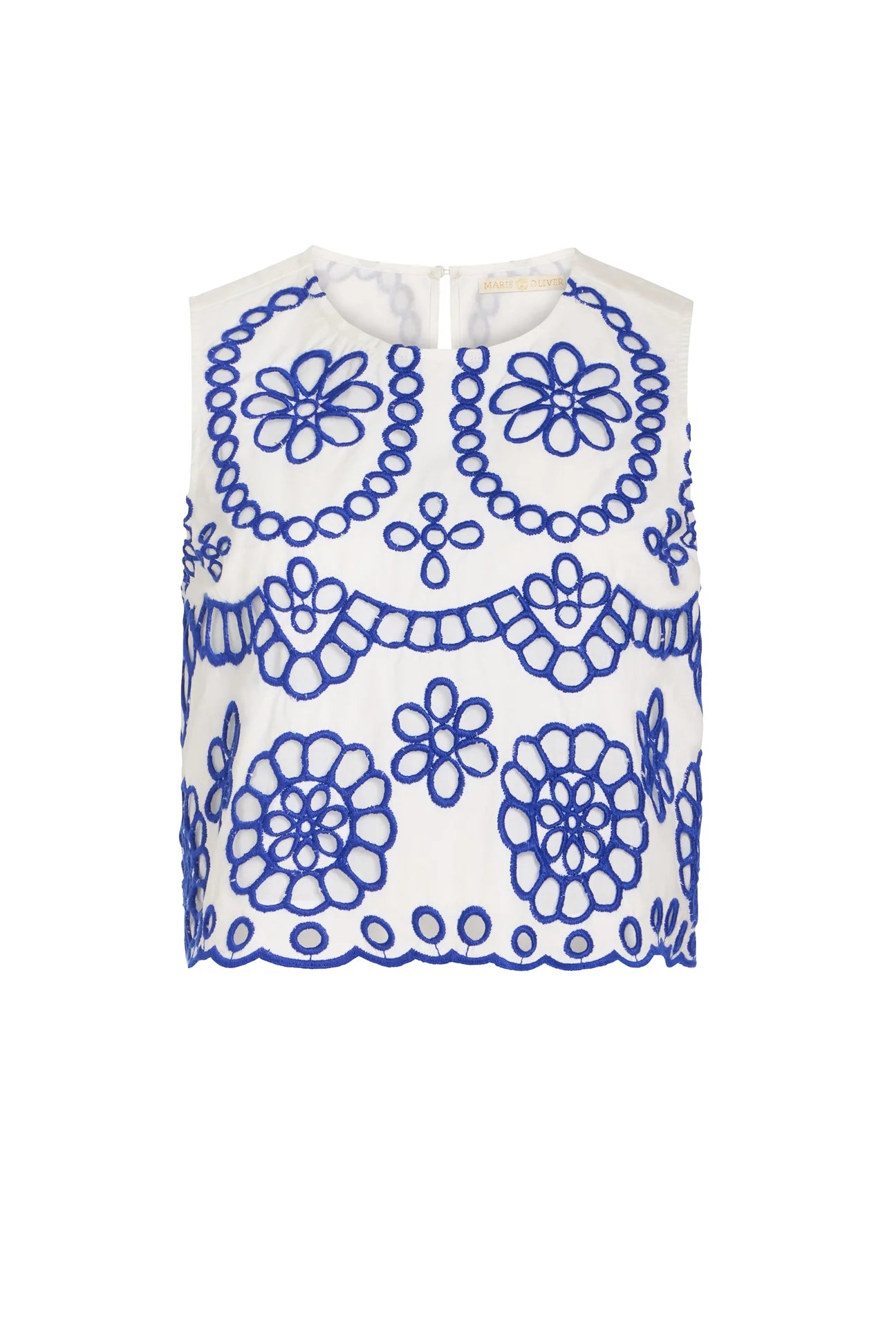 White sleeveless top with blue floral patterns on a white background