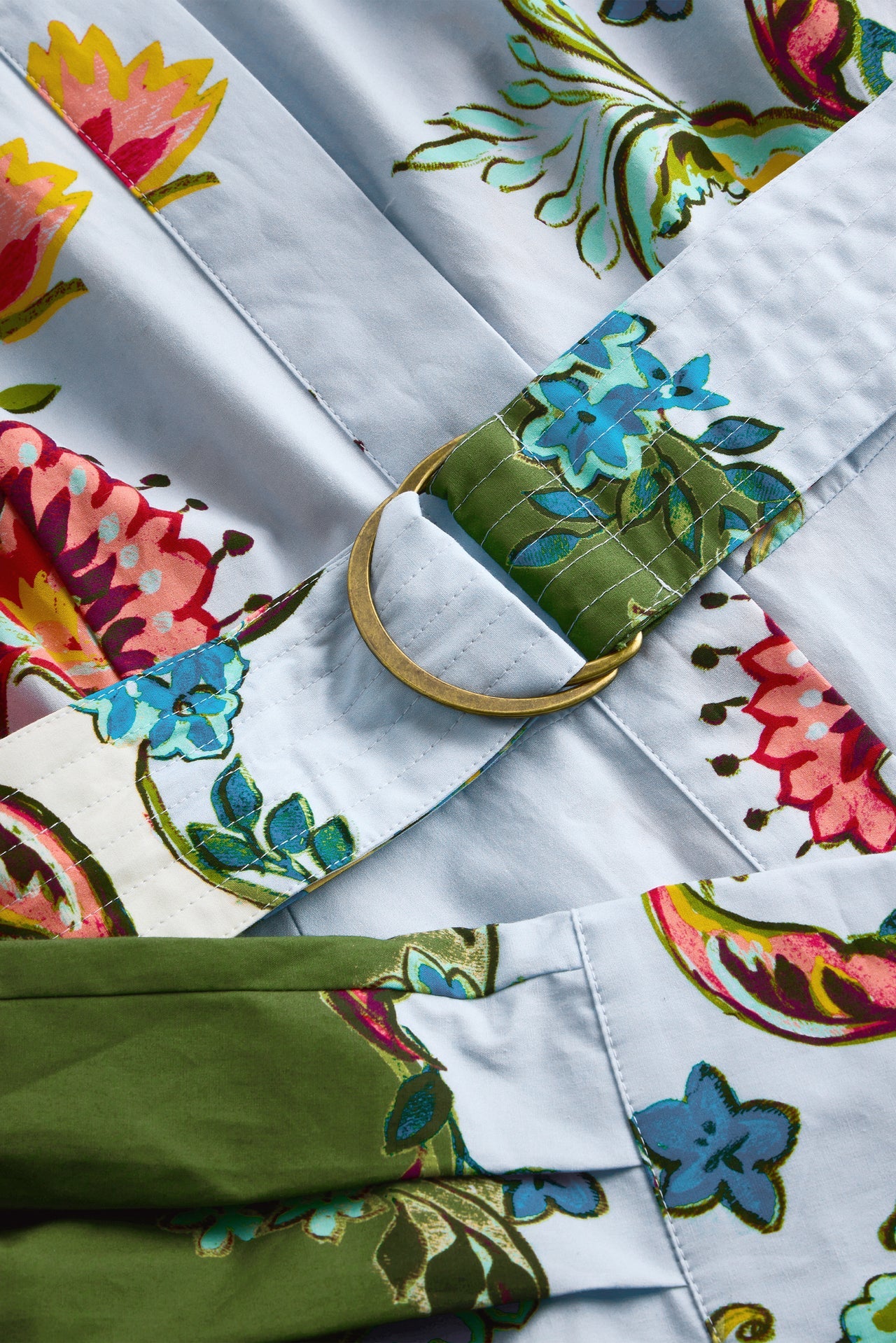 Floral-patterned fabric with a green bag and colorful flowers.