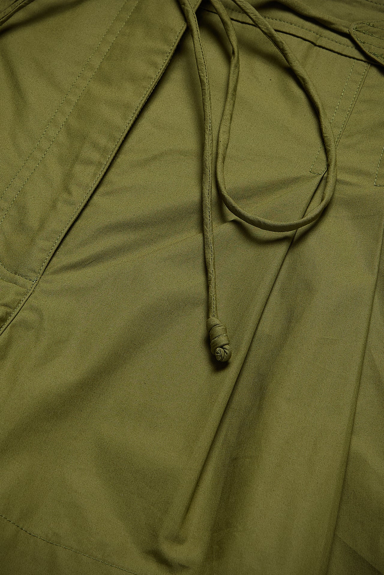 Close-up of a green jacket with a drawstring