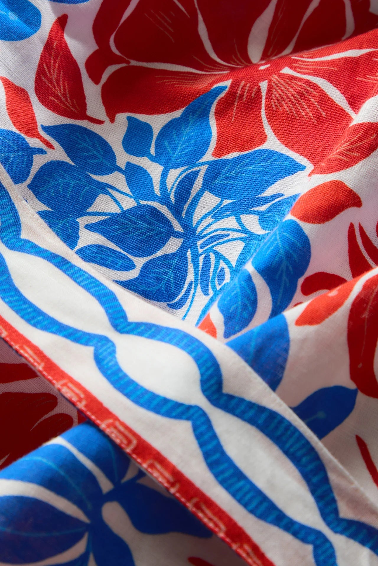Close-up of fabric with red, blue, and white floral pattern