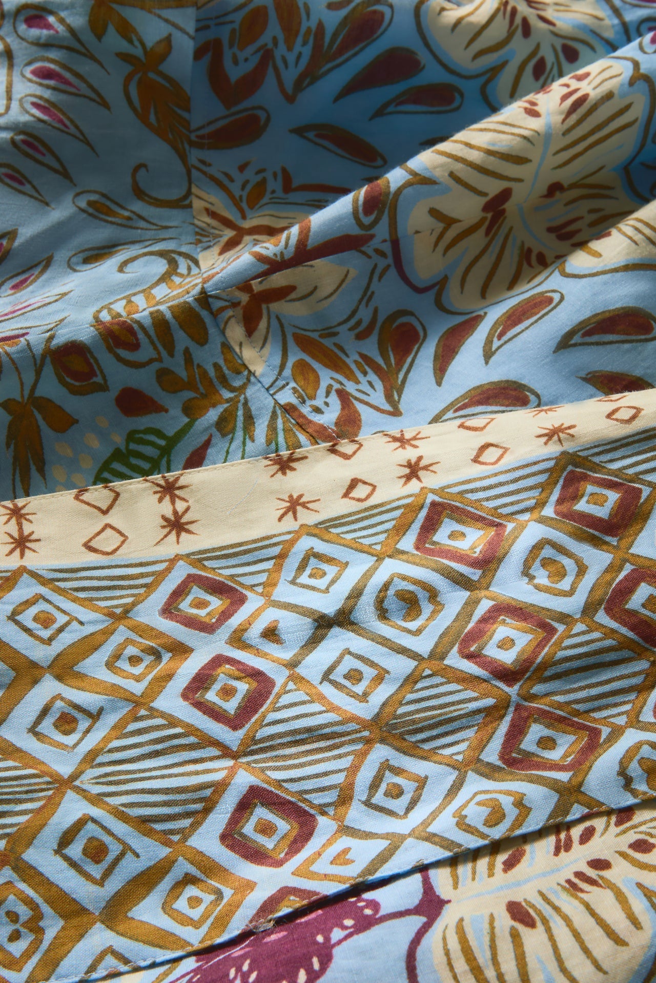 Close-up of patterned fabric with geometric and abstract designs.