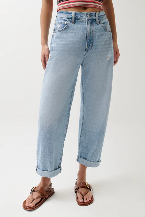 Light blue jeans worn by a person on a white background