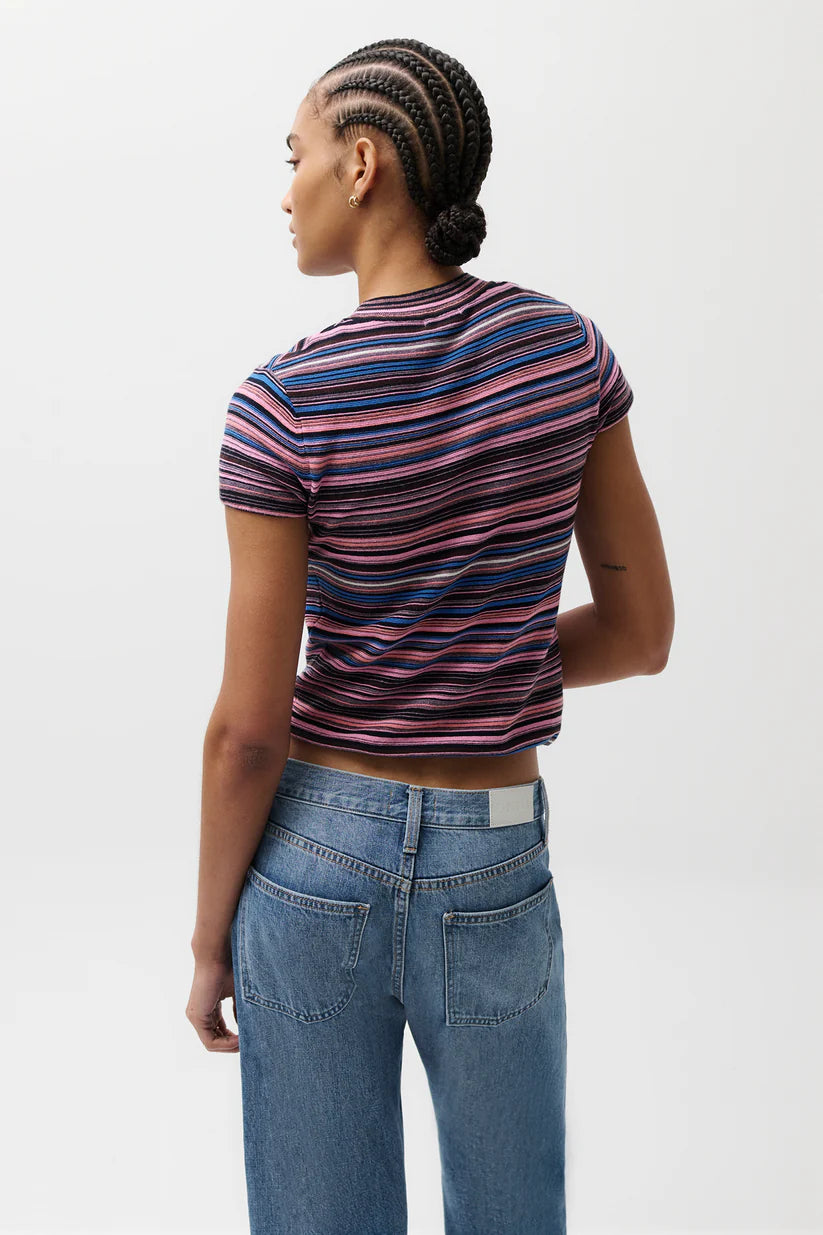 Person wearing a striped shirt and jeans on a white background