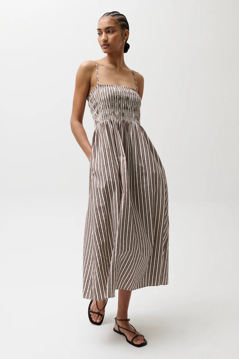 Woman wearing a striped dress on a white background