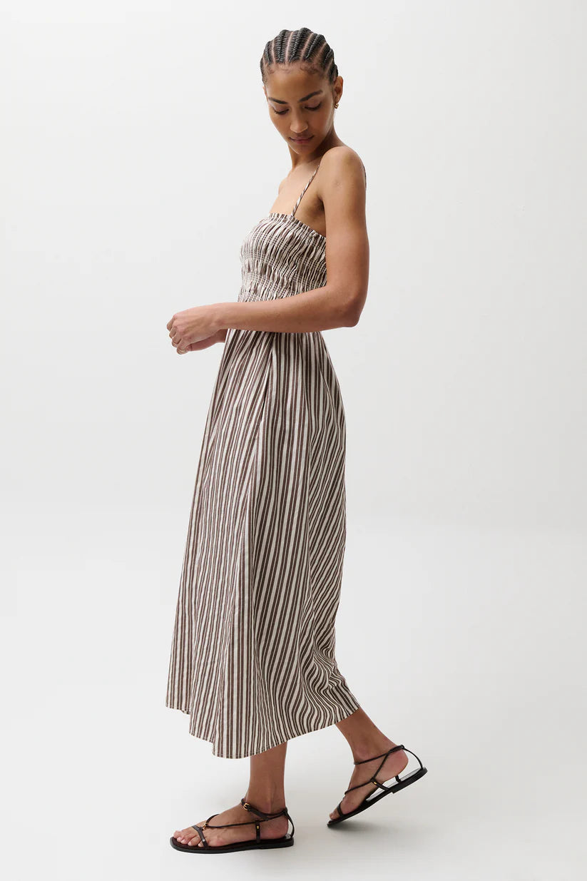 Woman wearing a striped dress on a white background