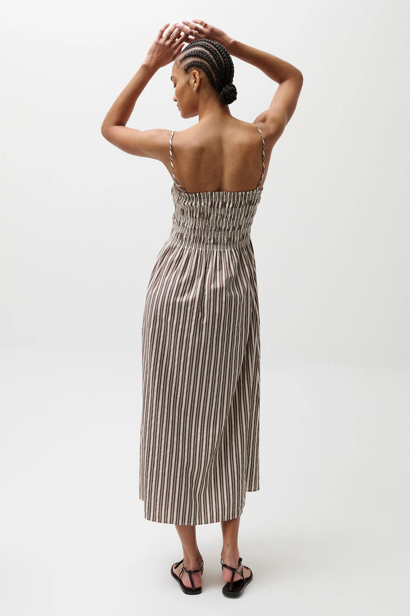 Woman wearing a striped dress on a white background