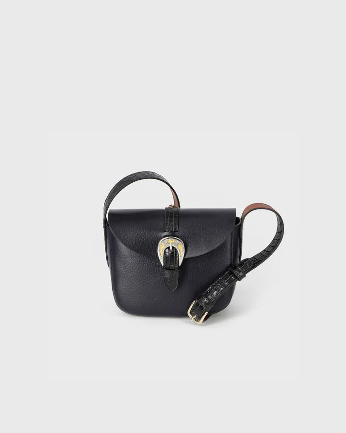 Black leather handbag with a strap on a light gray background