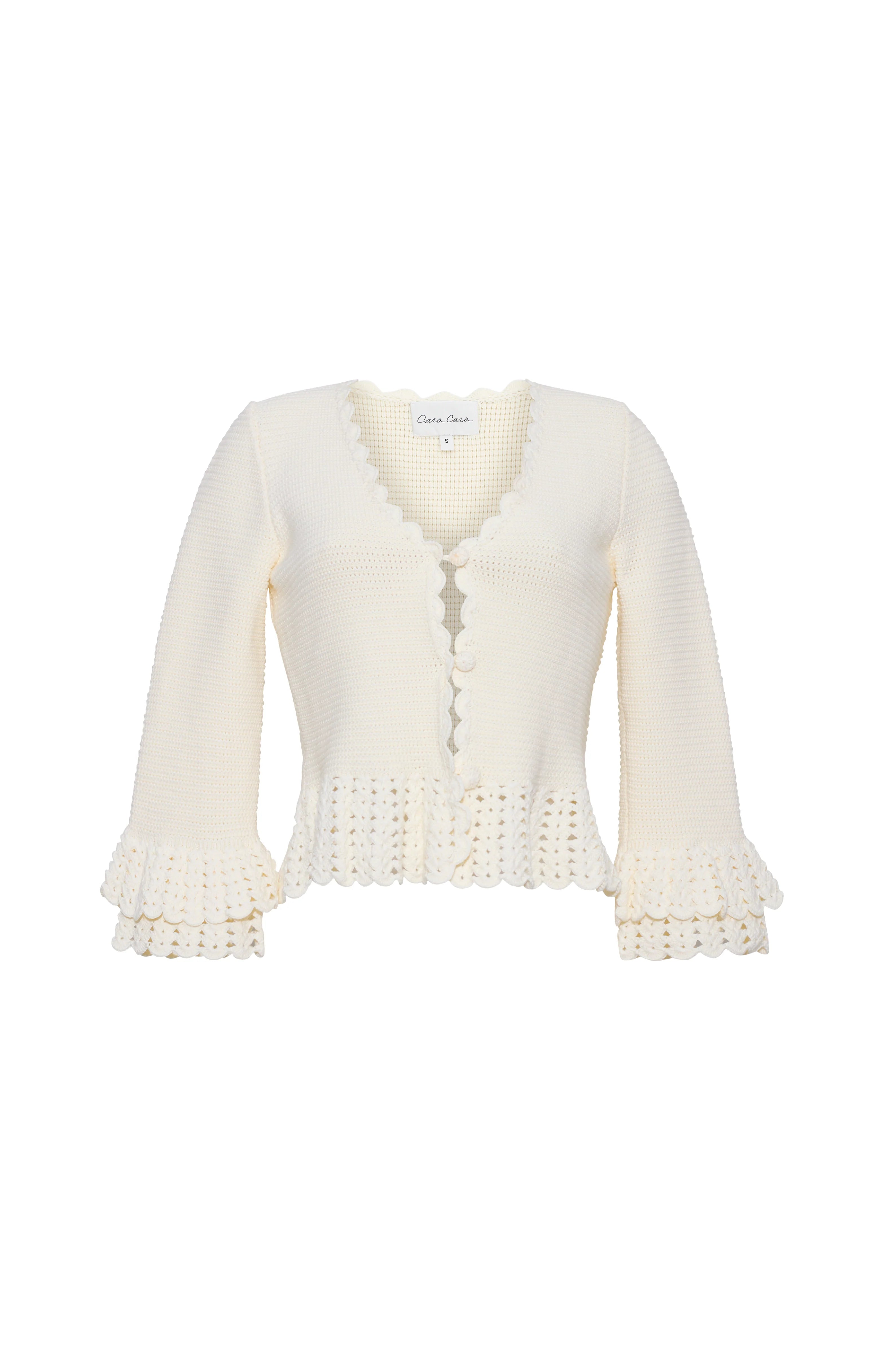 White cardigan with lace details on a white background