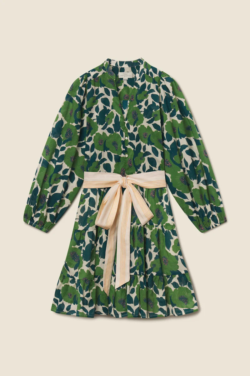 Green floral dress with a beige bow on a beige background