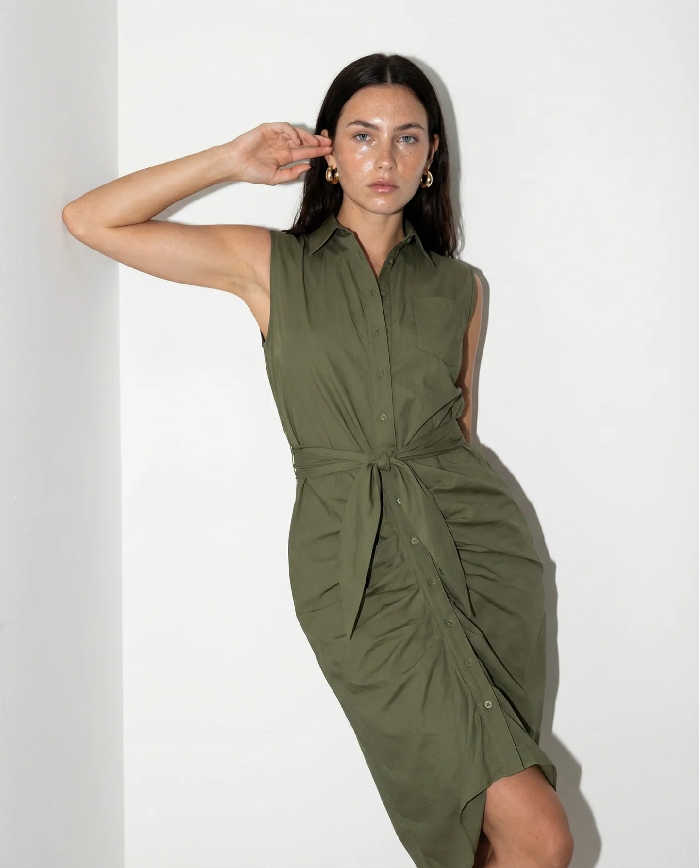 Woman wearing a green dress against a white background
