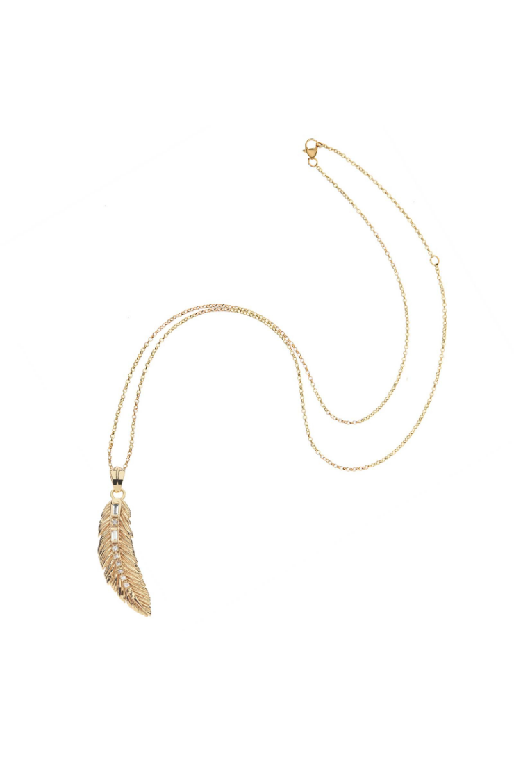 A gold-toned necklace featuring a detailed feather pendant on a delicate chain, displayed against a solid white background.